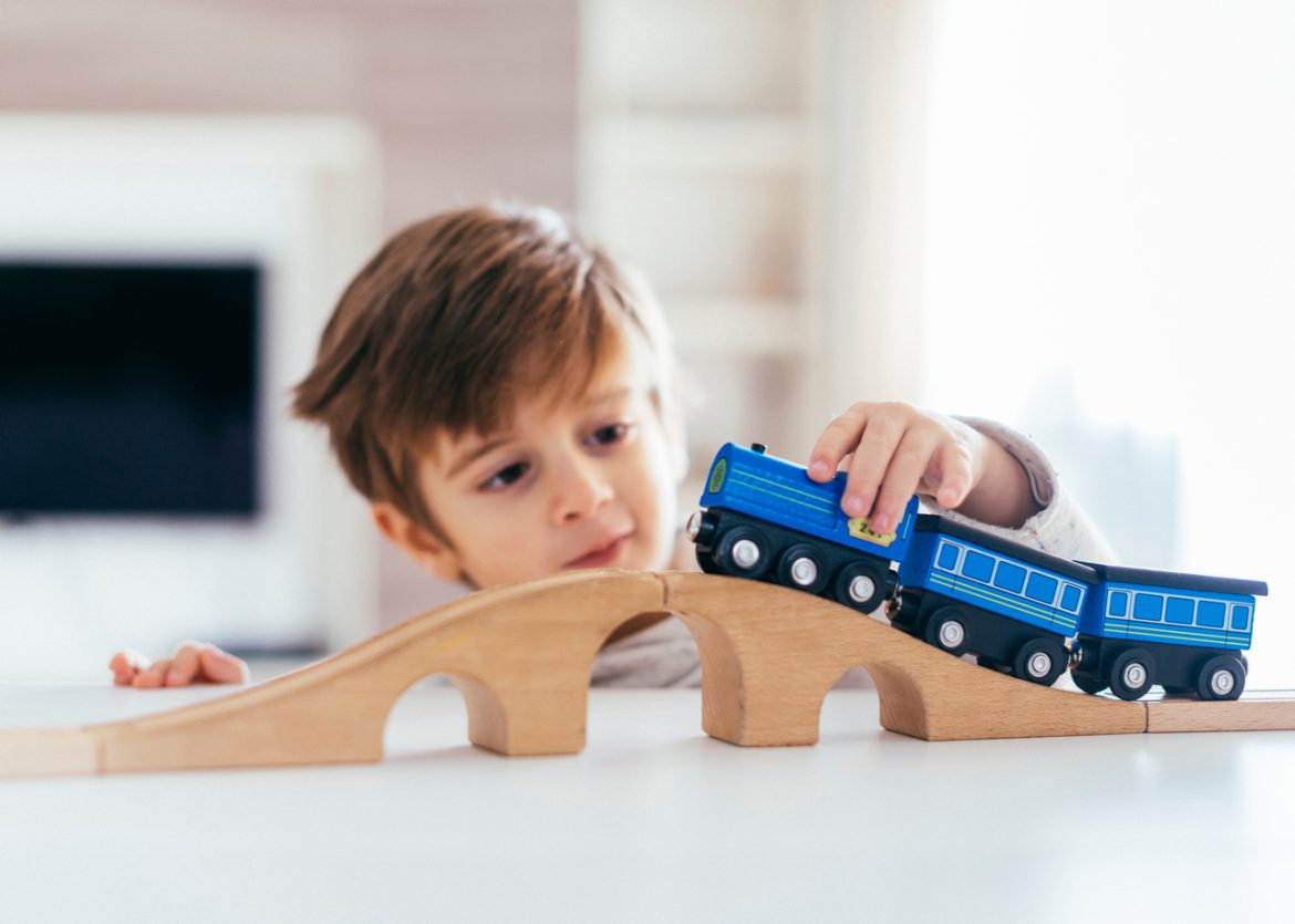kid-playing-with-toy-train