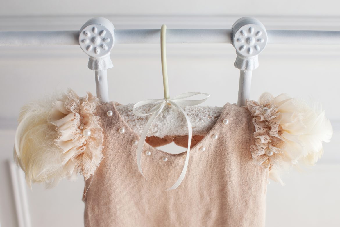Beige dress from wool and openwork details on a white background